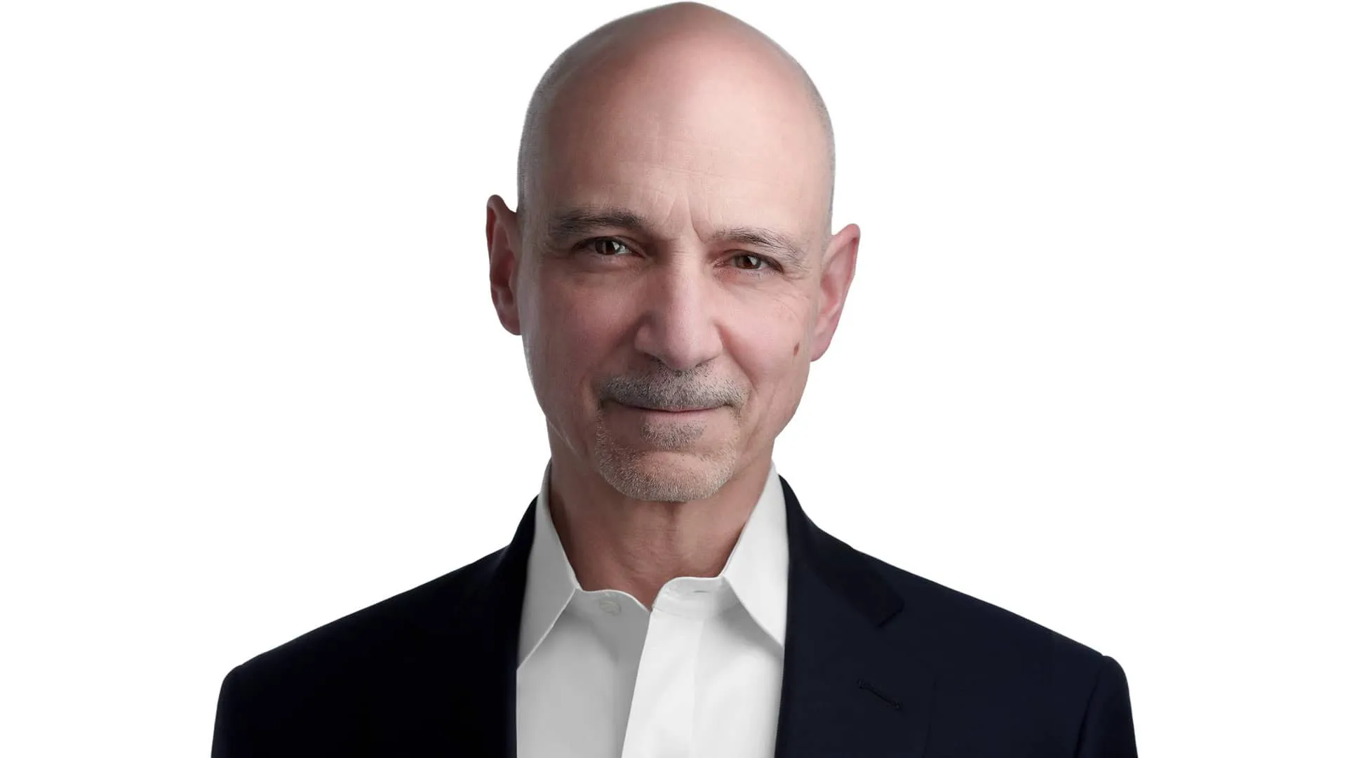 Professional headshot of male with bald head, grey goatee and facial hair, wearing black blazer over white collared dress shirt, photographed on seamless white background by Lancaster Pennsylvania headshot photographer Richard Waine