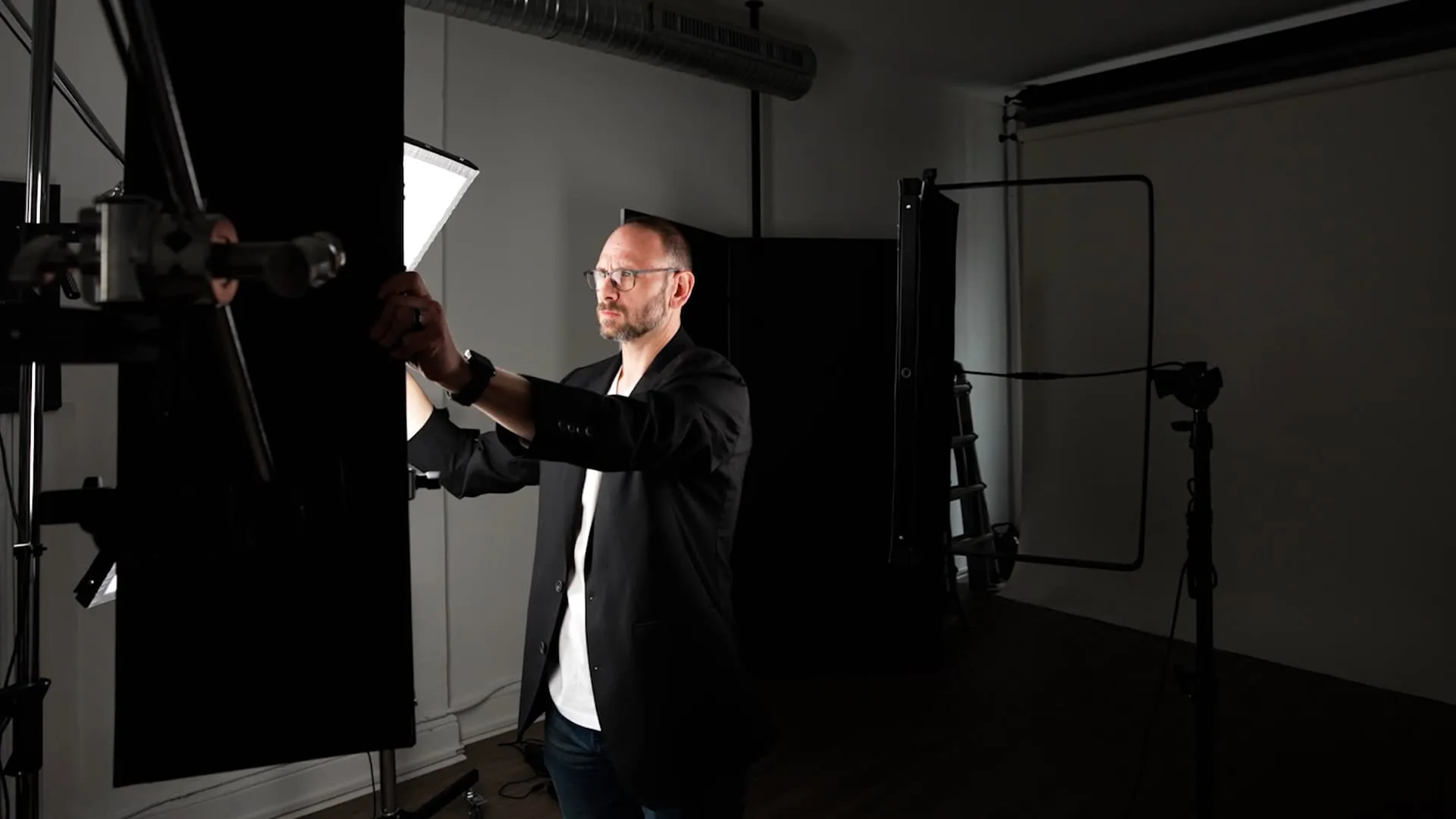 Richard Waine setting a light modifier during a headshot session in his Lancaster PA studio