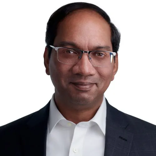 Professional executive headshot of man with receding hairline and rectangular glasses wearing dark suit jacket over white dress shirt against white studio background by Richard Waine Photography
